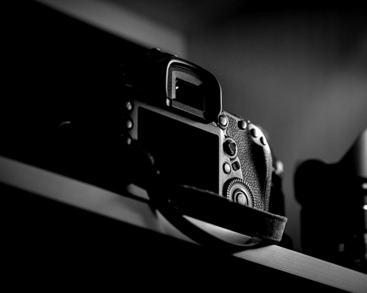 Group of students collaborating on video editing project around computer workstations